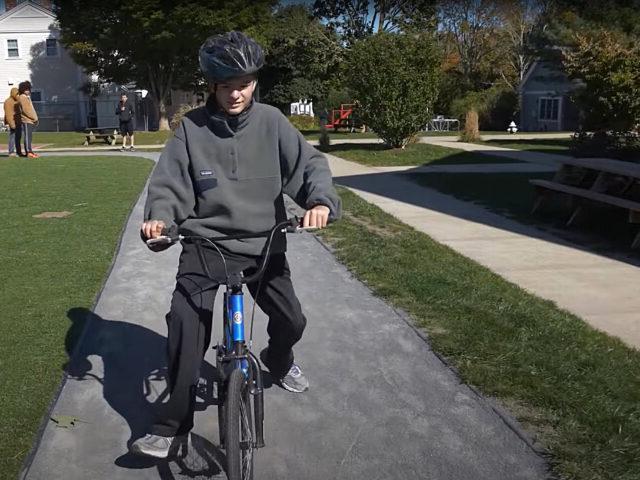 Student rides his bike on Latham Track